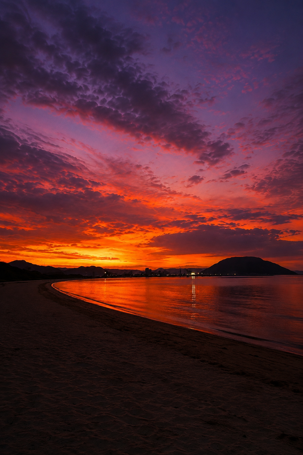 Sunset over the Karatsu coast in Saga with a mountain silhouette across the bay